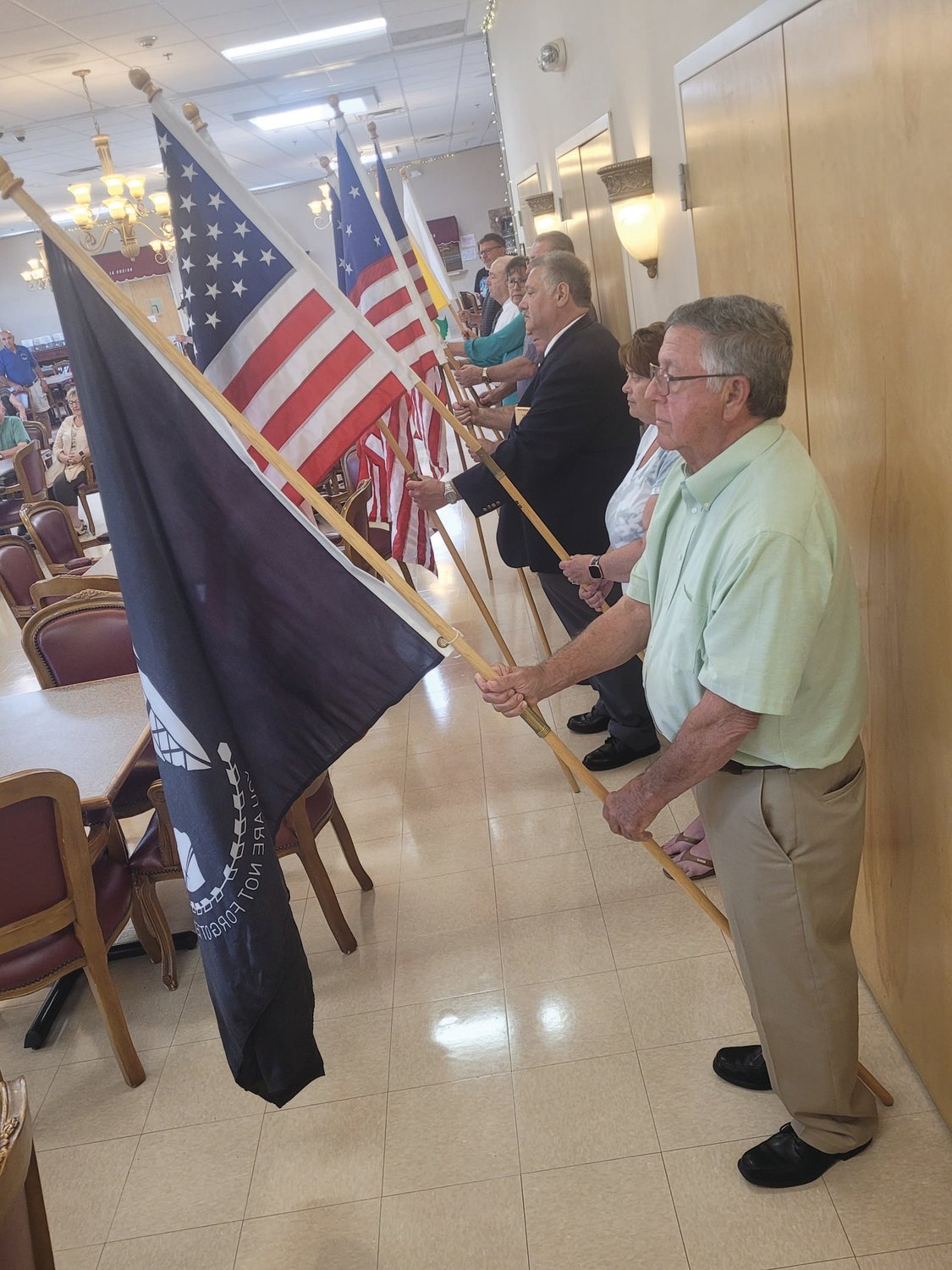 BANNERS UNITED: Members of Warwick’s Tri-City Elks Lodge held flags from throughout the American experience. From the original “Stars & Stripes” to an “MIA/POW” flag, patriotism was on full display during the Flag Day ceremony held at the Johnston Senior Center.